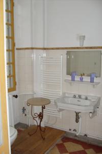a small bathroom with a sink and a toilet at Château De Serrigny in Ladoix Serrigny