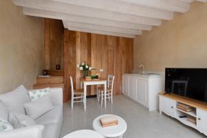 a living room with a couch and a table at Rambaldi Apartments Casa nr 4 in Bardolino