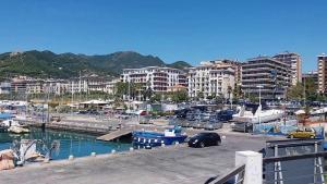 a marina with cars parked in the water and buildings at SOLIDEA BNB in Salerno
