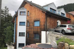 a house with a car parked in front of it at Haus Alpenblick A5 - CharmingStay in Flumserberg