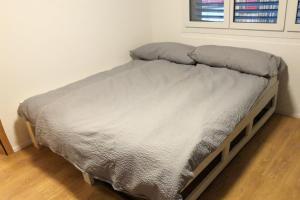 a small bed in a bedroom with a window at Haus Alpenblick A5 - CharmingStay in Flumserberg