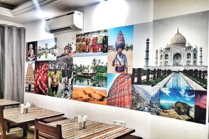 a wall with many pictures of monuments on it at Hotel Aerocity Purple Orchid in New Delhi