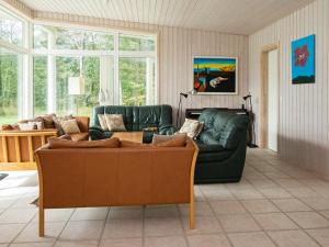 a living room with a couch and a table at 6 person holiday home in Knebel in Knebel