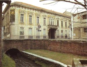 a large brick building with a clock on it at I Mulini B&B in Vigevano