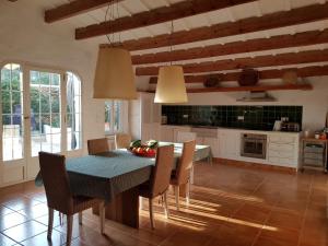 a kitchen with a table and chairs in a room at Son Blanc in Sant Lluis