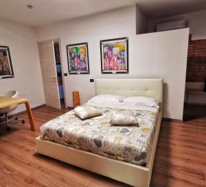 una camera con un letto con due cuscini sopra di Regis B&B Camere centro storico a Chivasso