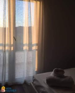 Postel nebo postele na pokoji v ubytování Aquarius Hotel