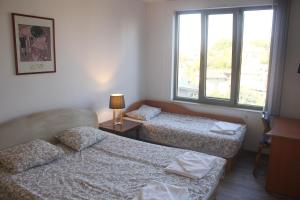 Postel nebo postele na pokoji v ubytování Central Square Apartment