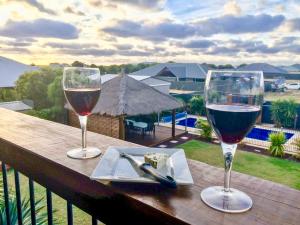 two glasses of wine sitting on a wooden table at Coastal Paradise Jurien Bay in Jurien Bay