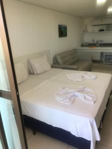 a bed with two towels on it in a room at Laguna Beach Flat in Porto De Galinhas