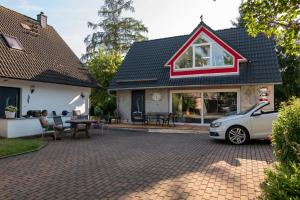 a house with a car parked in the driveway at Ferienhaus Görmer mit Wasserbett in Schmölln