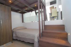 a small room with a bed and a staircase at Haraki Beauty in Haraki