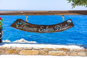 a sign that reads bahrain endless blues hanging on a wall at Ikarian Endless Blue in Kouniádhoi