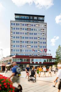 a group of people walking in front of a building at Quality Hotel Bodensia in Boden