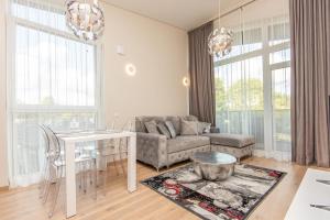 a living room with a couch and a table at Luxury harmony in Vanagupe in Palanga