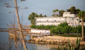 a bridge over a body of water with a building at Hotel Restaurant Juanito Platja in Sant Carles de la Ràpita