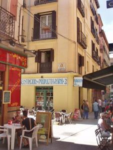a group of people sitting at tables on a city street at Foster Apartamentos Sol in Madrid