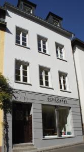 a white building with a store front at Schlössje in Lieser