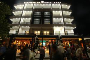 a crowd of people in front of a building at night at HOTEL IMPERIAL STRUGA in Struga
