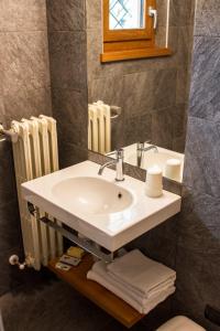 a bathroom with a sink and a mirror at Albergo Ristorante Cuccini in San Domenico +21 photos