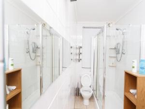 a white bathroom with a toilet and a shower at Ruth Apartments in Leeds