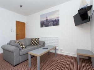 a living room with a couch and a coffee table at Ruth Apartments in Leeds