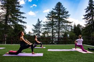 a group of people doing yoga on the grass at Albergo Ristorante Cuccini in San Domenico