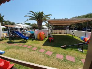 a backyard with a playground with a slide at Alexaria Holidays Homes in Lefkada