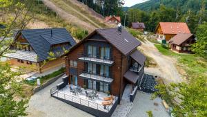 an overhead view of a house with a man standing on the roof at Chata Monumento in Valča