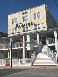 
a hotel room with a large white building behind it at The Admiral Hotel/Motel in Ocean City
