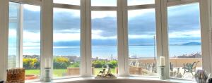 a view of the ocean from a kitchen window at HomeStay In The Bay With Sea Views in Heysham