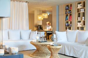 a living room with a white couch and a table at Lighthouse Hotel & Spa in Büsum