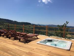 a hot tub on a deck with tables and chairs at AGRITURISMO INCISA in Bagno di Romagna
