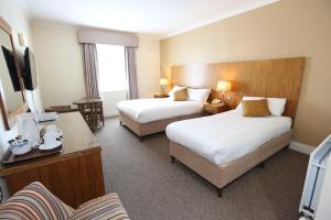 a hotel room with two beds and a television at Auburn Lodge Hotel & Leisure Centre in Ennis +22 photos