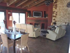 a living room with a table and chairs and a fireplace at CASA ARENS in Arens de Lledó