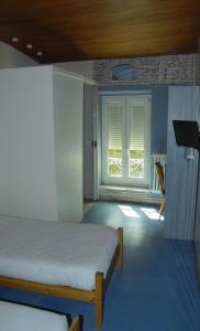 Postel nebo postele na pokoji v ubytování Hotel Les Passions + 1 fotografie