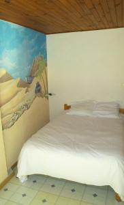 Säng eller sängar i ett rum på Hotel Les Passions