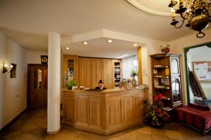 a woman sitting at a counter in a kitchen at Hotel Alt-Ringlein in Bamberg