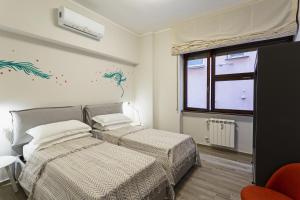 A bed or beds in a room at Genova XXV Aprile by Wonderful Italy