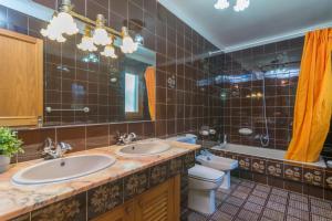 a bathroom with two sinks and a toilet and a mirror at S'Olivaret -Alcudia- in Port d'Alcudia +27 photos