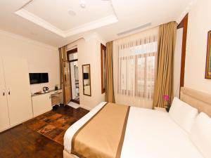 Postel nebo postele na pokoji v ubytování Nusretbey Hotel