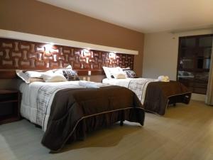 Postel nebo postele na pokoji v ubytování 9 Estrellas Casa Hotel