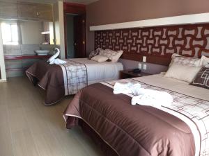 Postel nebo postele na pokoji v ubytování 9 Estrellas Casa Hotel