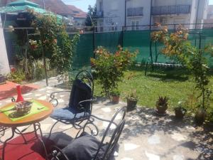 a patio with a table and chairs and plants at Noa.s Pansion 88 in Vrnjačka Banja
