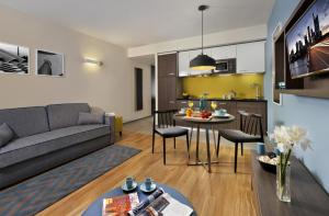 a living room with a couch and a table at Citadines City Centre Frankfurt in Frankfurt/Main