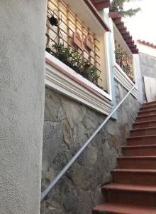 a staircase leading up to a building with a window at TAVERNETTA SUL PORTO in Ischia +15 photos