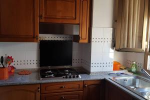 a kitchen counter with a stove and a sink at La casa di Ulisse 008055- LT0806 in Sanremo +12 photos