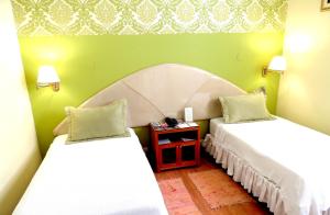 Cama ou camas em um quarto em Lima Wari Hotel Boutique
