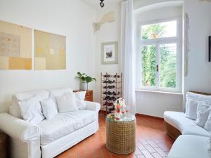 a living room with a white couch and a window at Albergo Garnì Villa Moretti in Riva del Garda