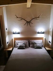 a bedroom with a large bed with two pillows at CHALET REMI-STELLA ALPINA in Livigno